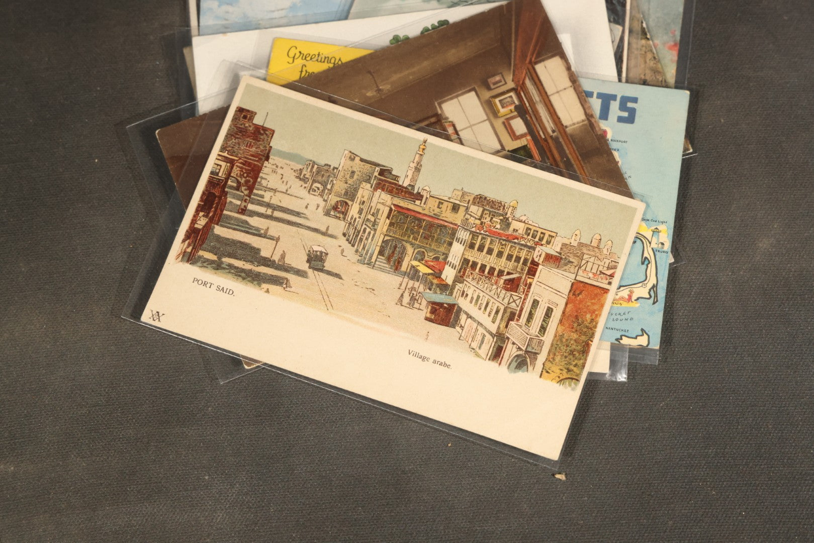 "Liza's Picks" Grouping of 30 Antique and Vintage Postcards including Massachusetts Map, Indian Sweetmeat Seller, Hebrew-Inscribed Cards, Castle Architecture, and Religious Subjects