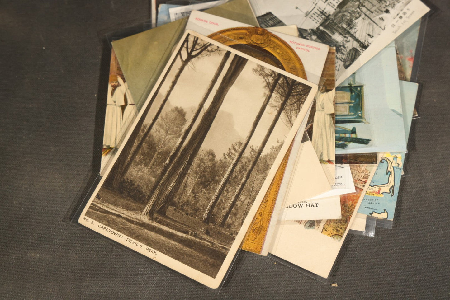 "Liza's Picks" Grouping of 30 Antique and Vintage Postcards including Massachusetts Map, Indian Sweetmeat Seller, Hebrew-Inscribed Cards, Castle Architecture, and Religious Subjects