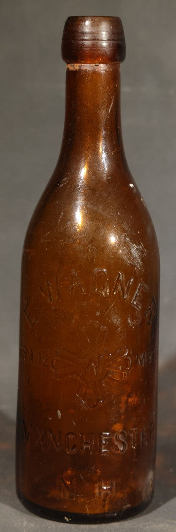 Grouping of Five Antique Embossed Glass Bottles including Moxie Nerve Food, Father John's Medicine, and Hood's Sarsaparilla
