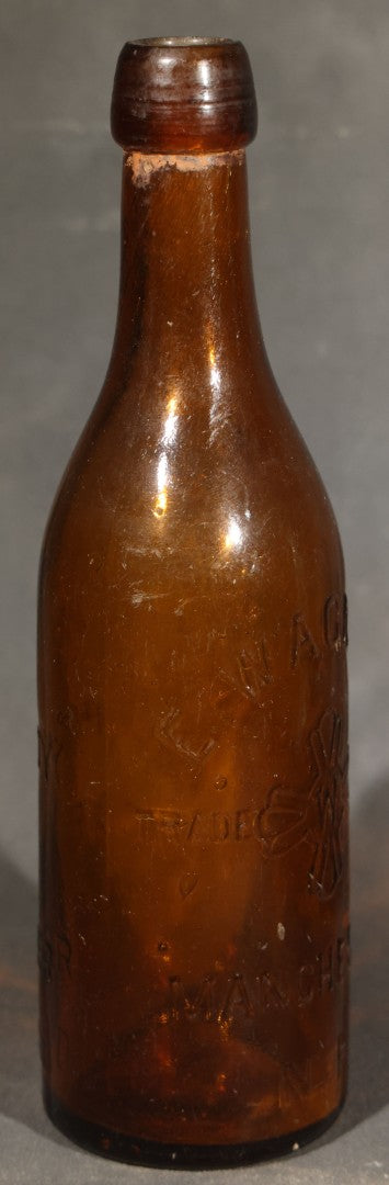 Grouping of Five Antique Embossed Glass Bottles including Moxie Nerve Food, Father John's Medicine, and Hood's Sarsaparilla