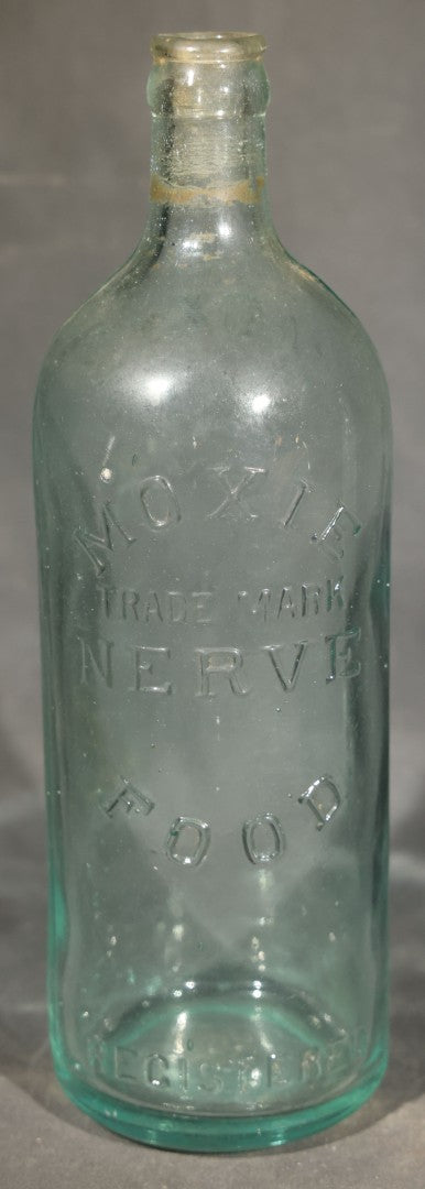 Grouping of Five Antique Embossed Glass Bottles including Moxie Nerve Food, Father John's Medicine, and Hood's Sarsaparilla