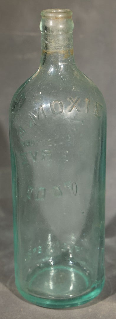 Grouping of Five Antique Embossed Glass Bottles including Moxie Nerve Food, Father John's Medicine, and Hood's Sarsaparilla