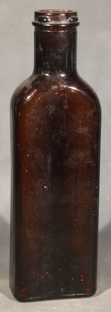Grouping of Five Antique Embossed Glass Bottles including Moxie Nerve Food, Father John's Medicine, and Hood's Sarsaparilla