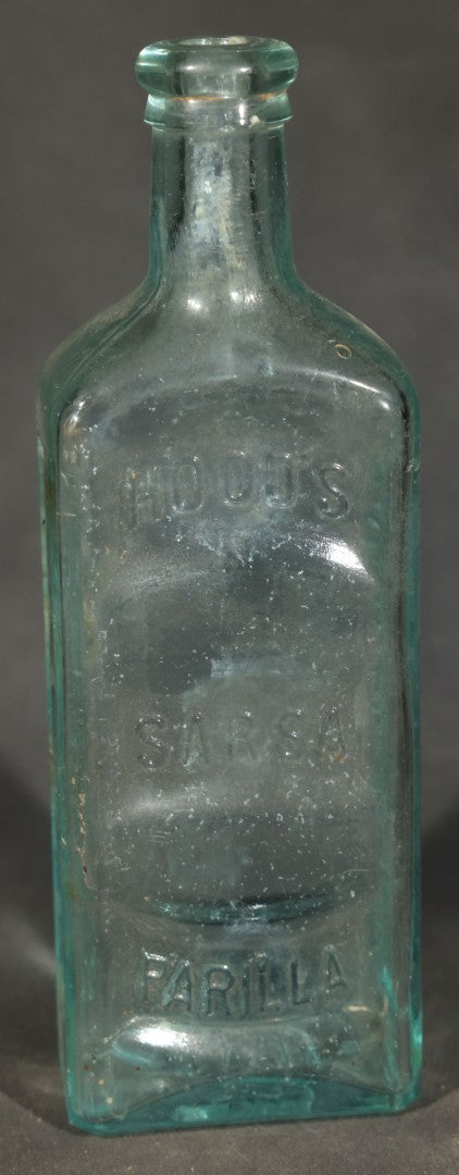 Grouping of Five Antique Embossed Glass Bottles including Moxie Nerve Food, Father John's Medicine, and Hood's Sarsaparilla