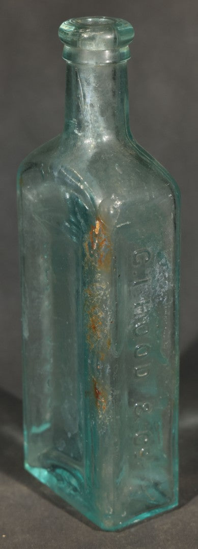 Grouping of Five Antique Embossed Glass Bottles including Moxie Nerve Food, Father John's Medicine, and Hood's Sarsaparilla