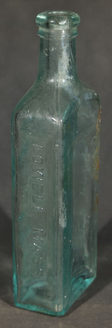 Grouping of Five Antique Embossed Glass Bottles including Moxie Nerve Food, Father John's Medicine, and Hood's Sarsaparilla
