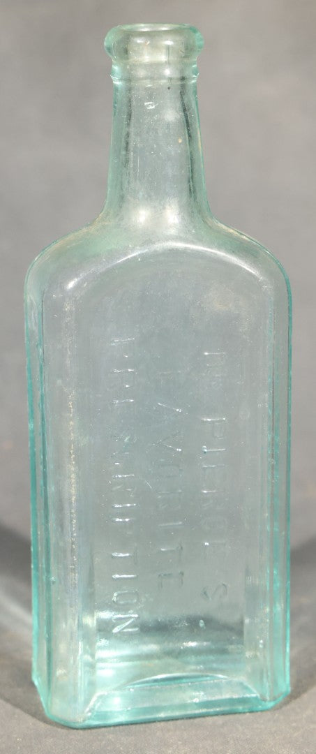 Grouping of Five Antique Embossed Glass Bottles including Moxie Nerve Food, Father John's Medicine, and Hood's Sarsaparilla