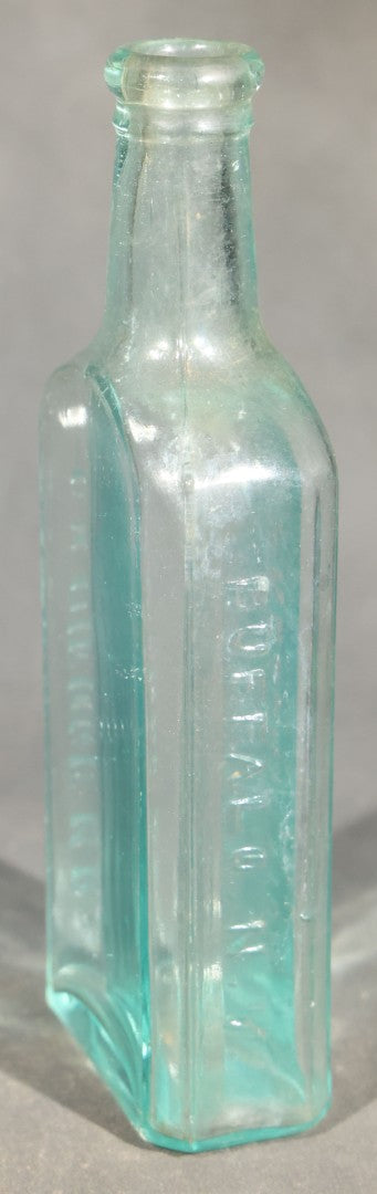 Grouping of Five Antique Embossed Glass Bottles including Moxie Nerve Food, Father John's Medicine, and Hood's Sarsaparilla