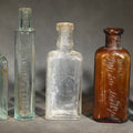 Lot 065 - Grouping of Five Antique Embossed Glass Bottles Including Remington and Gibbs Sulpho-Napthol
