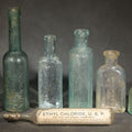 Lot 066 - Grouping of Seven Antique Glass Bottles Including Ethyl Chloride U.S.P. Anaesthesia Tube and Embossed Pharmaceutical Bottles