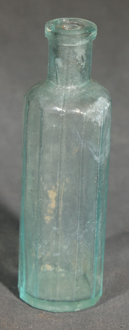 Grouping of Seven Antique Glass Bottles including Ethyl Chloride U.S.P. Anaesthesia Tube and Embossed Pharmaceutical Bottles