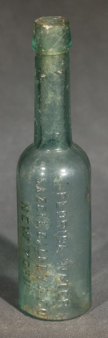 Grouping of Seven Antique Glass Bottles including Ethyl Chloride U.S.P. Anaesthesia Tube and Embossed Pharmaceutical Bottles