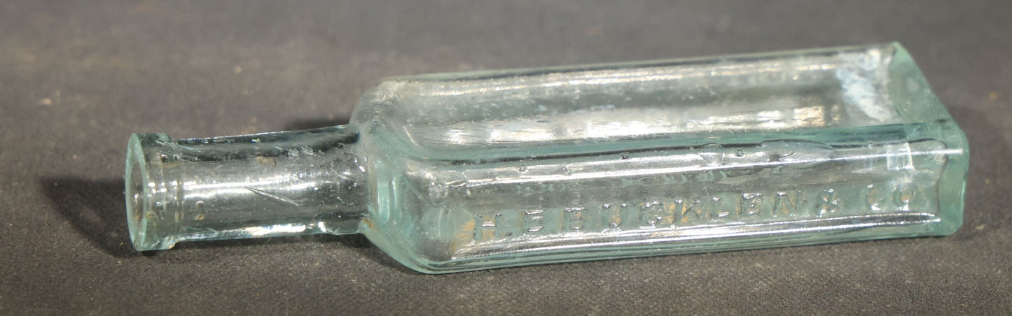 Grouping of Seven Antique Glass Bottles including Ethyl Chloride U.S.P. Anaesthesia Tube and Embossed Pharmaceutical Bottles