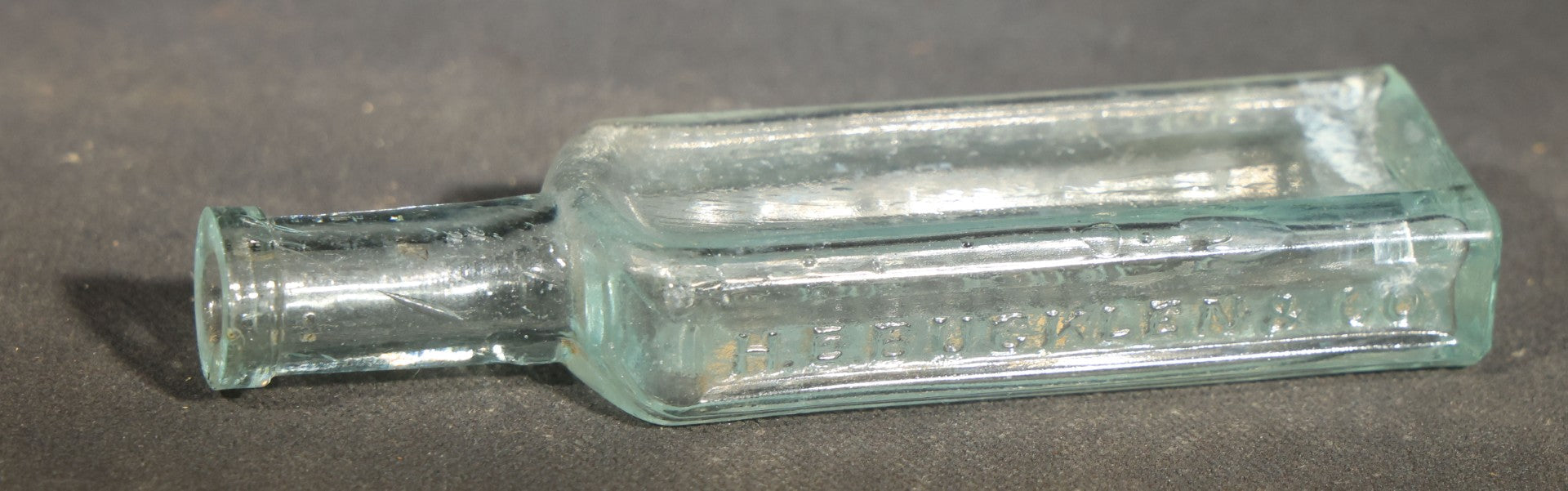 Grouping of Seven Antique Glass Bottles including Ethyl Chloride U.S.P. Anaesthesia Tube and Embossed Pharmaceutical Bottles