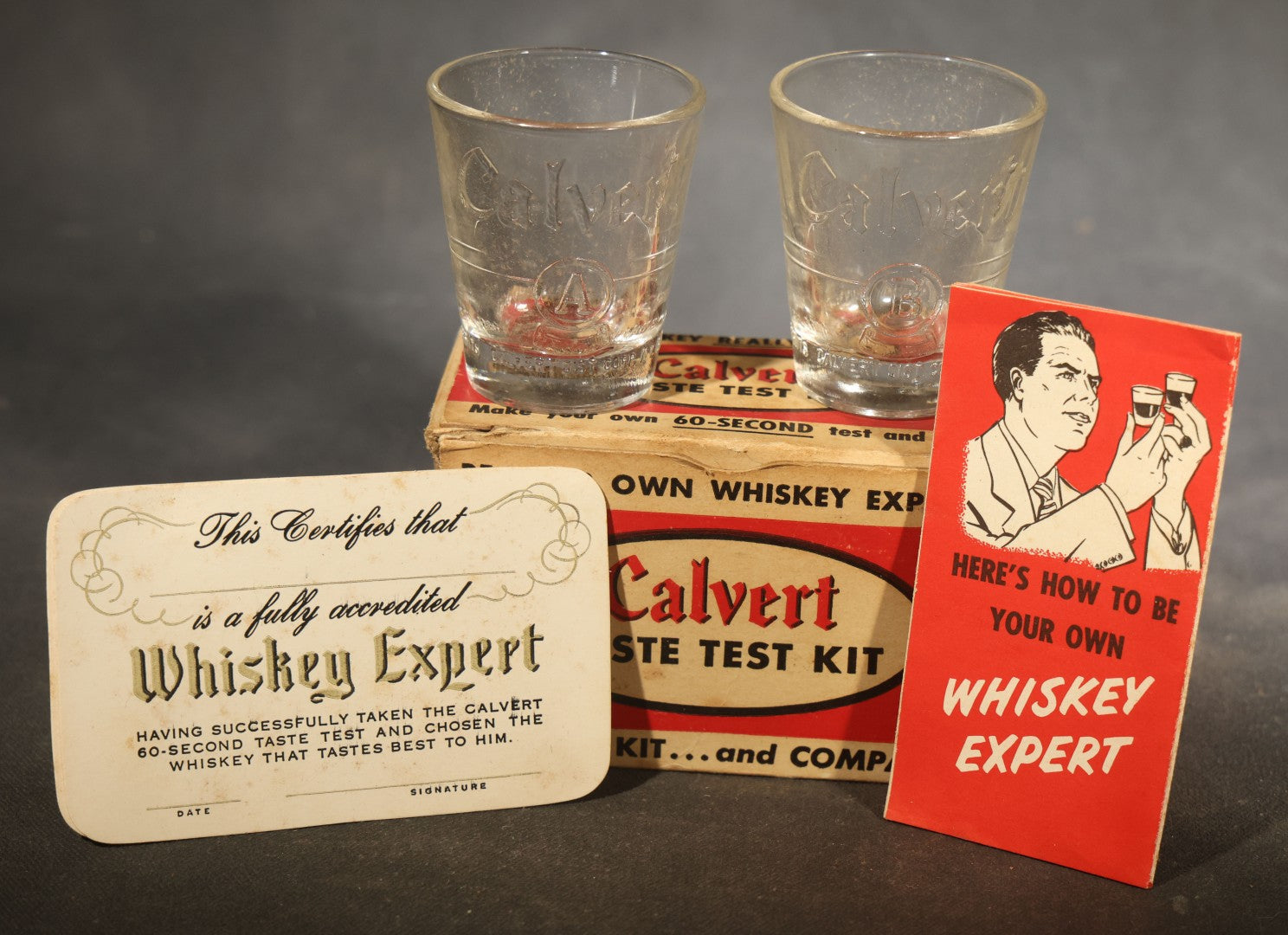 Vintage Calvert Whiskey Taste Test Kit Advertising Novelty with Two Embossed Shot Glasses, "Whiskey Expert" Certificate Cards, and Instruction Pamphlet in Original Box