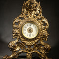 Lot 006 - Antique Cast Brass Rococo Revival Style Mantel Clock with Winged Cherub, Grotesque Masks, and Scrolling Foliate Design, Signed A.F., Patented 1902-1908, Made in U.S.A., 10-1/2" H