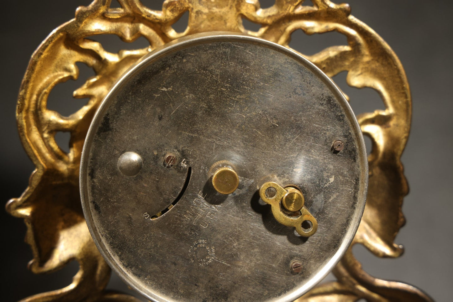 Antique Cast Brass Rococo Revival Style Mantel Clock with Winged Cherub, Grotesque Masks, and Scrolling Foliate Design, Signed A.F., Patented 1902-1908, Made in U.S.A.