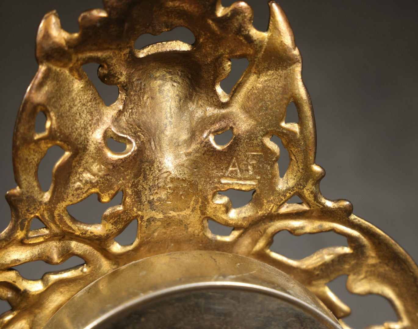Antique Cast Brass Rococo Revival Style Mantel Clock with Winged Cherub, Grotesque Masks, and Scrolling Foliate Design, Signed A.F., Patented 1902-1908, Made in U.S.A.