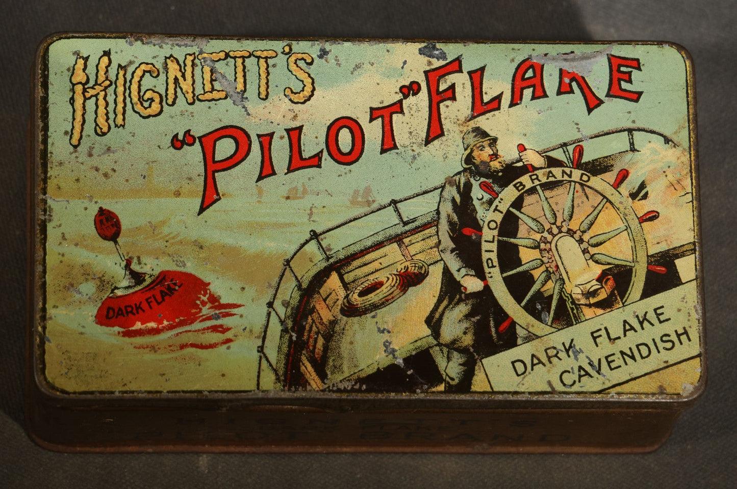 Antique Hignett's "Pilot" Flake Dark Flake Cavendish Tobacco Tin with Ship's Helmsman Graphic