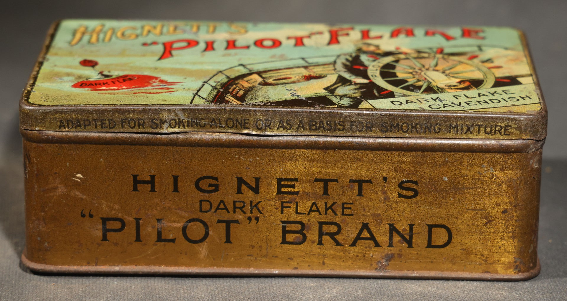Antique Hignett's "Pilot" Flake Dark Flake Cavendish Tobacco Tin with Ship's Helmsman Graphic