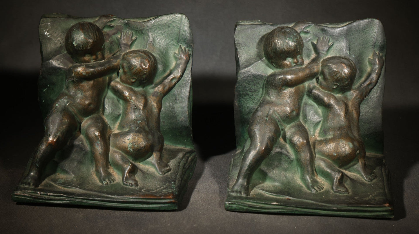 Pair of Antique Green-Patinated Bookends with Two Putti / Cherubs in Relief, Signed and Dated 1903, Manufactured by WAL Co.