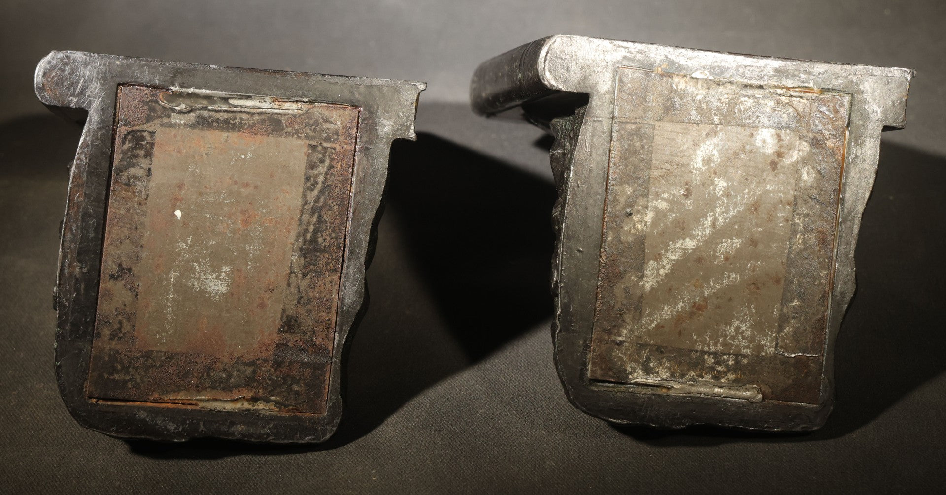 Pair of Antique Figural Bookends with Butterfly-Winged Child Seated Against Book-Form Back
