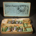 Lot 033 - Antique German "Glücks-Figuren Mit Scherzeinlagen" ("Lucky Figures with Joke Inserts") Bleigießen Fortune-Telling Set with Eight Lead Figurines Including Pig, Zeppelin, Mushroom, and Wizard