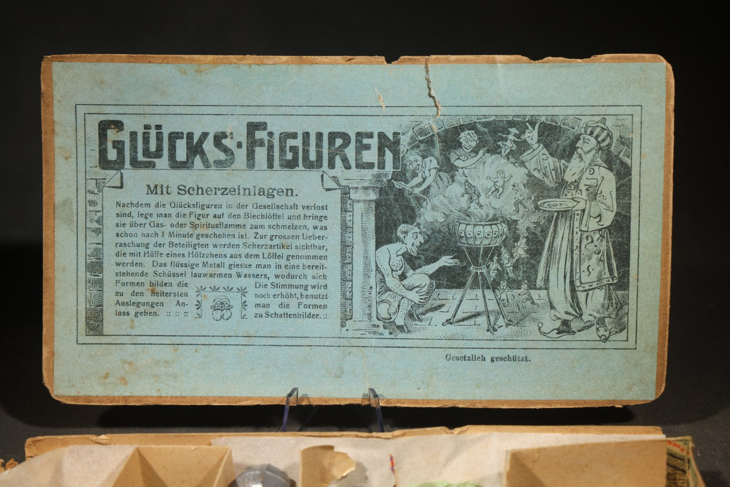 Antique German "Glücks-Figuren mit Scherzeinlagen" ("Lucky Figures with Joke Inserts") Bleigießen Fortune-Telling Set with Eight Lead Figurines including Pig, Zeppelin, Mushroom, and Wizard