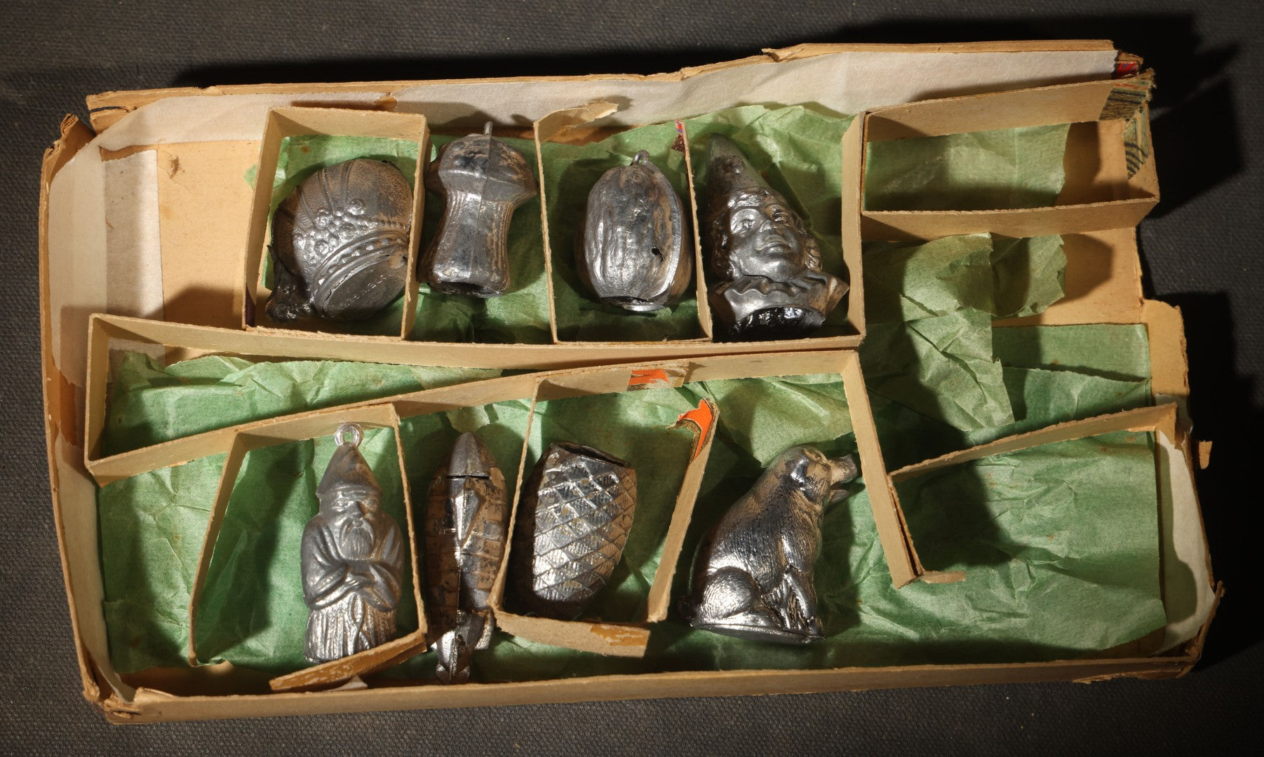 Antique German "Glücks-Figuren mit Scherzeinlagen" ("Lucky Figures with Joke Inserts") Bleigießen Fortune-Telling Set with Eight Lead Figurines including Pig, Zeppelin, Mushroom, and Wizard