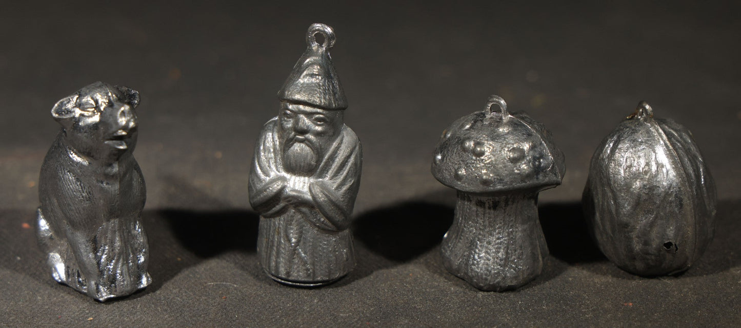 Antique German "Glücks-Figuren mit Scherzeinlagen" ("Lucky Figures with Joke Inserts") Bleigießen Fortune-Telling Set with Eight Lead Figurines including Pig, Zeppelin, Mushroom, and Wizard