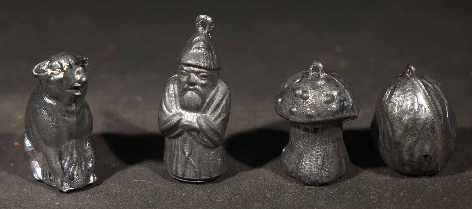 Antique German "Glücks-Figuren mit Scherzeinlagen" ("Lucky Figures with Joke Inserts") Bleigießen Fortune-Telling Set with Eight Lead Figurines including Pig, Zeppelin, Mushroom, and Wizard