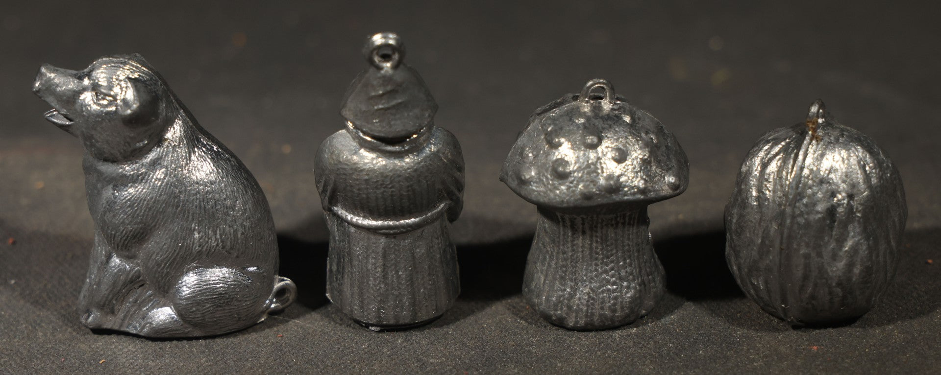 Antique German "Glücks-Figuren mit Scherzeinlagen" ("Lucky Figures with Joke Inserts") Bleigießen Fortune-Telling Set with Eight Lead Figurines including Pig, Zeppelin, Mushroom, and Wizard