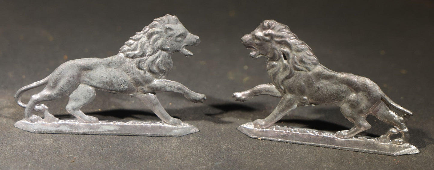 Grouping of Nine Antique German Zinnfiguren Flat Tin Figures including Camels, Lions, Bucking Bronco Rider, and Trees