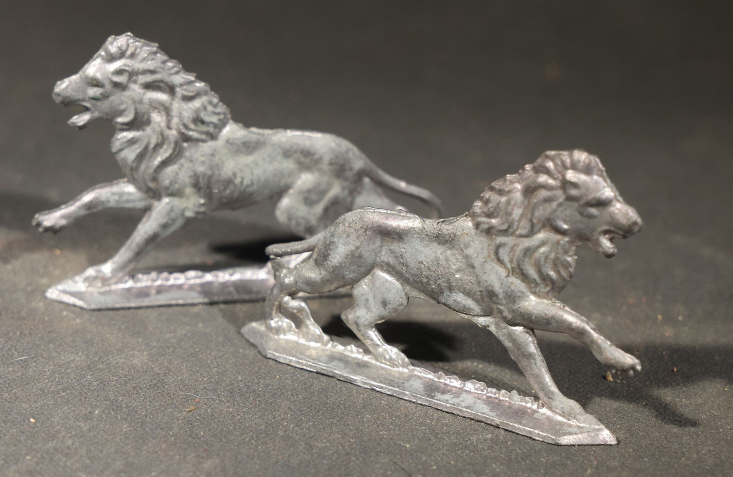 Grouping of Nine Antique German Zinnfiguren Flat Tin Figures including Camels, Lions, Bucking Bronco Rider, and Trees