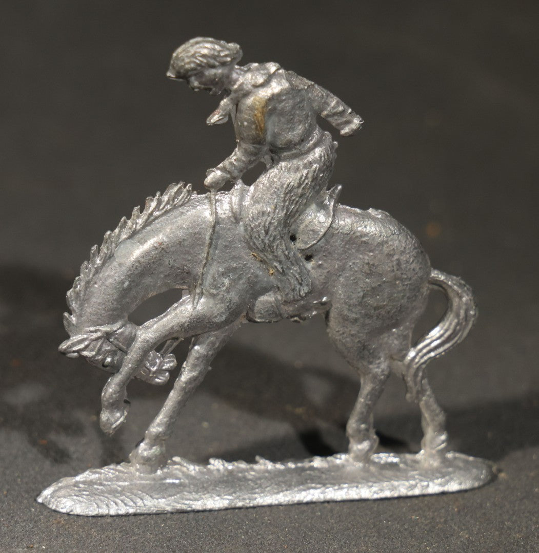 Grouping of Nine Antique German Zinnfiguren Flat Tin Figures including Camels, Lions, Bucking Bronco Rider, and Trees