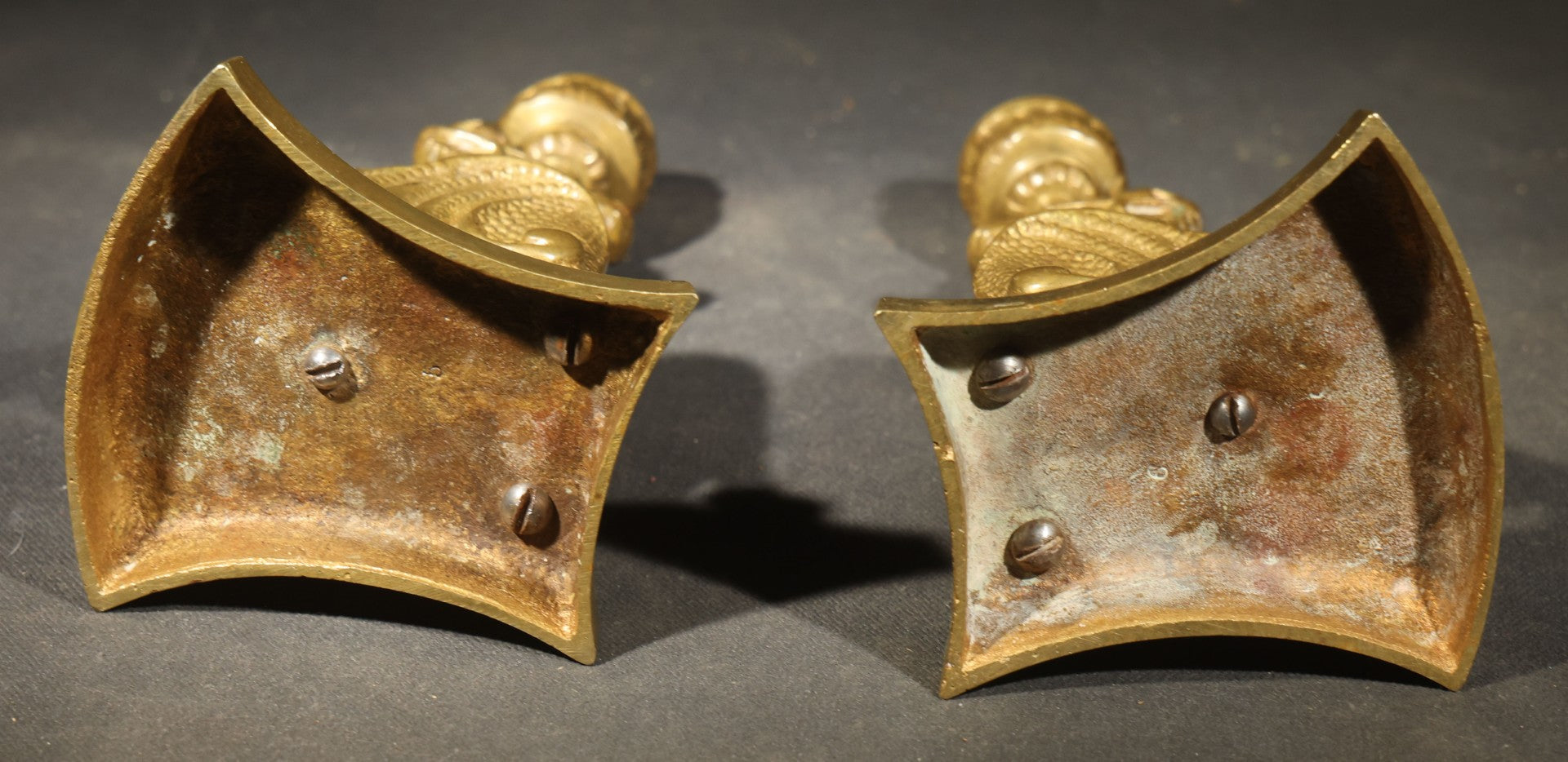 Pair of Antique Brass Figural Dragon or Griffin Candlesticks with Foliate Candle Cups on Shaped Bases