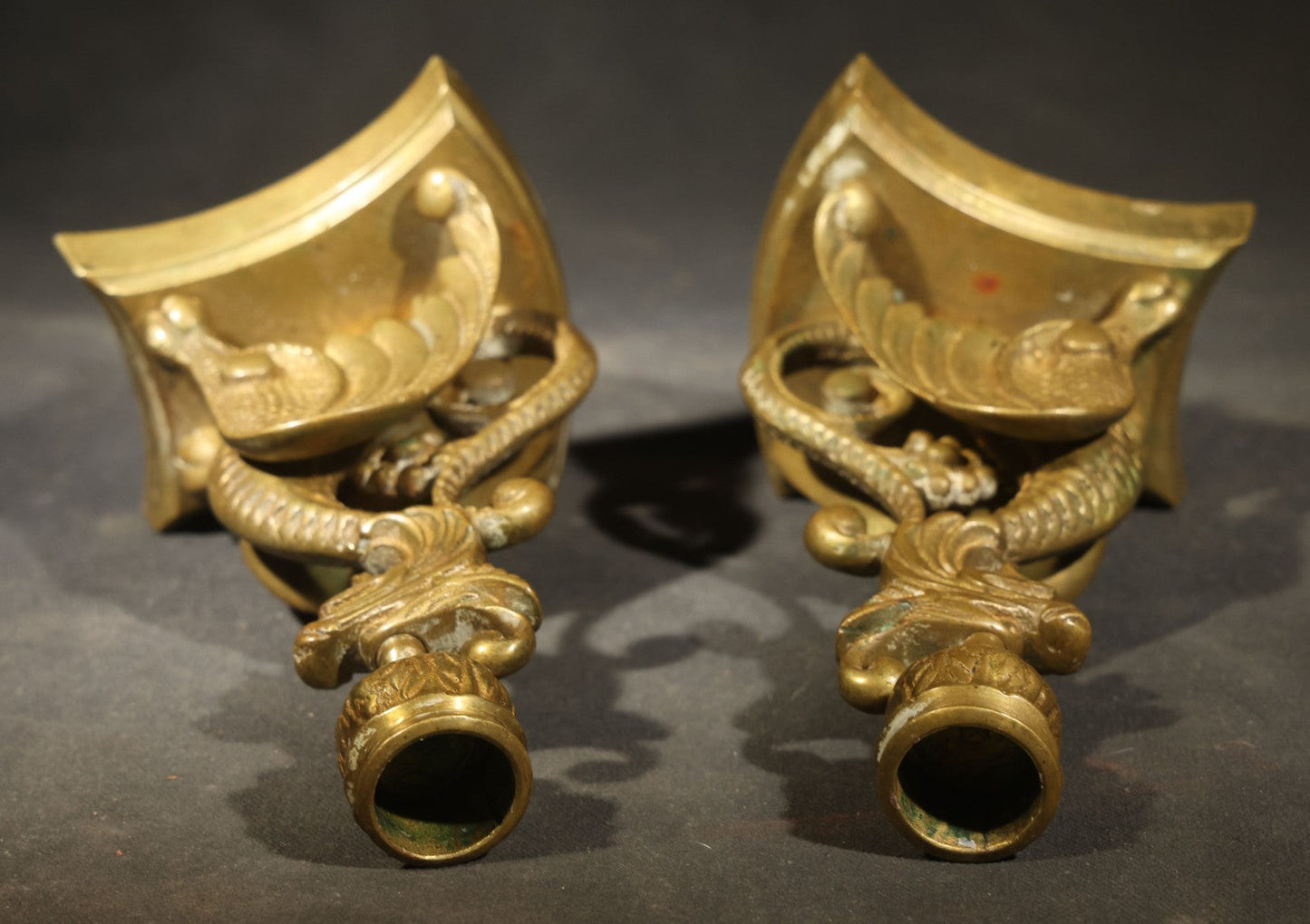 Pair of Antique Brass Figural Dragon or Griffin Candlesticks with Foliate Candle Cups on Shaped Bases