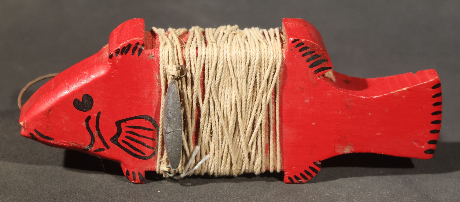 Grouping of Three Antique and Vintage Folk Art Pieces including Bamboo Cup with Crossed American and Cuban Flags, Red Painted Wooden Fish Line Winder, and "Whoopee" Man in Top Hat Figure