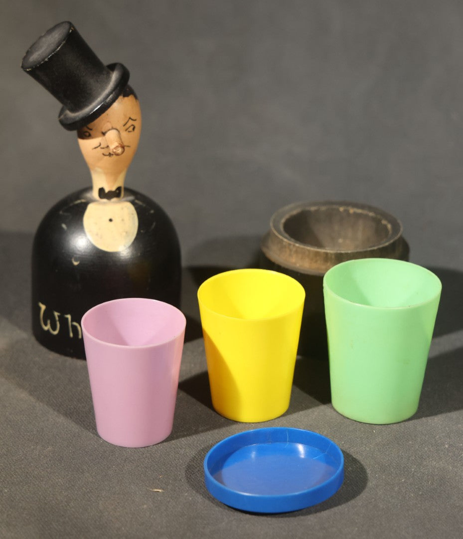 Grouping of Three Antique and Vintage Folk Art Pieces including Bamboo Cup with Crossed American and Cuban Flags, Red Painted Wooden Fish Line Winder, and "Whoopee" Man in Top Hat Figure