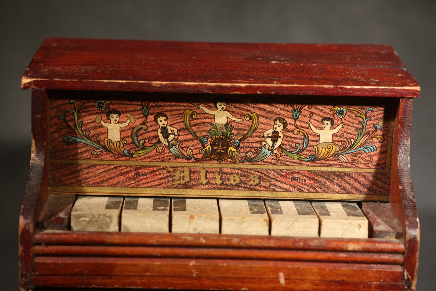 Antique Bliss Wooden Toy Piano with Lithographed Cherub and Scroll Graphics, Eight Keys
