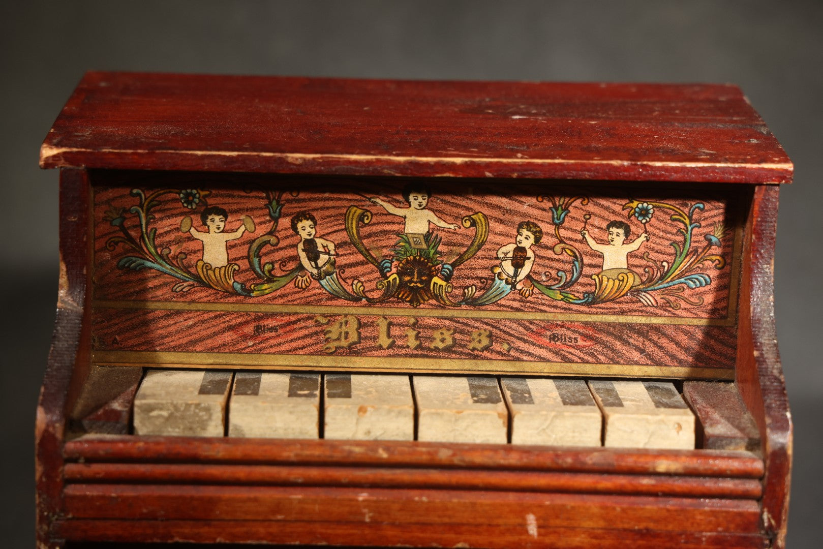 Antique Bliss Wooden Toy Piano with Lithographed Cherub and Scroll Graphics, Eight Keys
