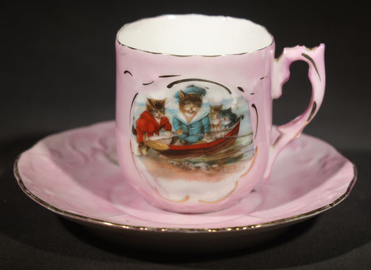 Antique German Pink Porcelain Demitasse Cup and Saucer with Anthropomorphic Cats in a Rowboat, Note Chip to Handle