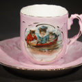 Lot 053 - Antique German Pink Porcelain Demitasse Cup and Saucer with Anthropomorphic Cats in a Rowboat, Note Chip to Handle, 2-1/2" H