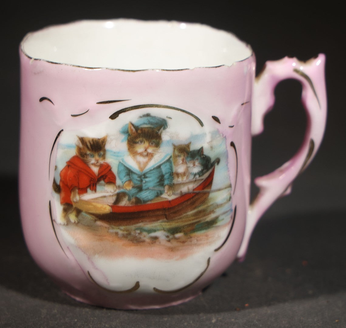 Antique German Pink Porcelain Demitasse Cup and Saucer with Anthropomorphic Cats in a Rowboat, Note Chip to Handle
