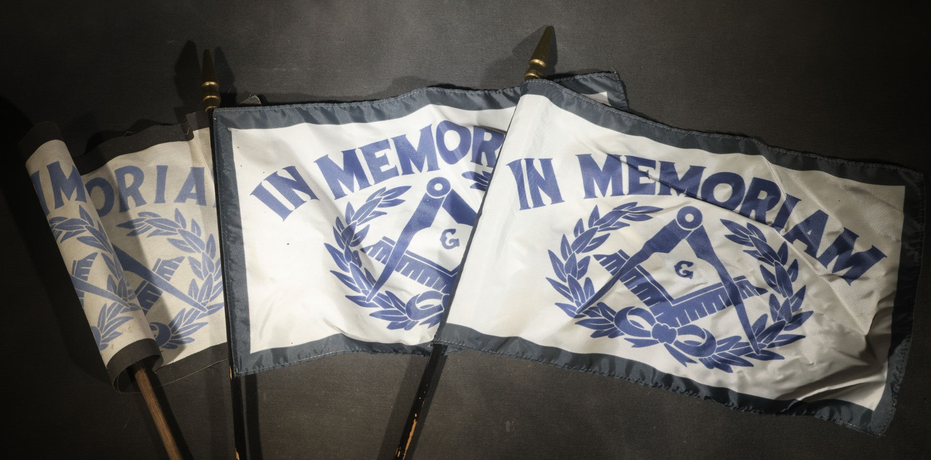 Trio of Modern Masonic "In Memoriam" Flags with Square and Compass and Laurel Wreath Design on Staffs
