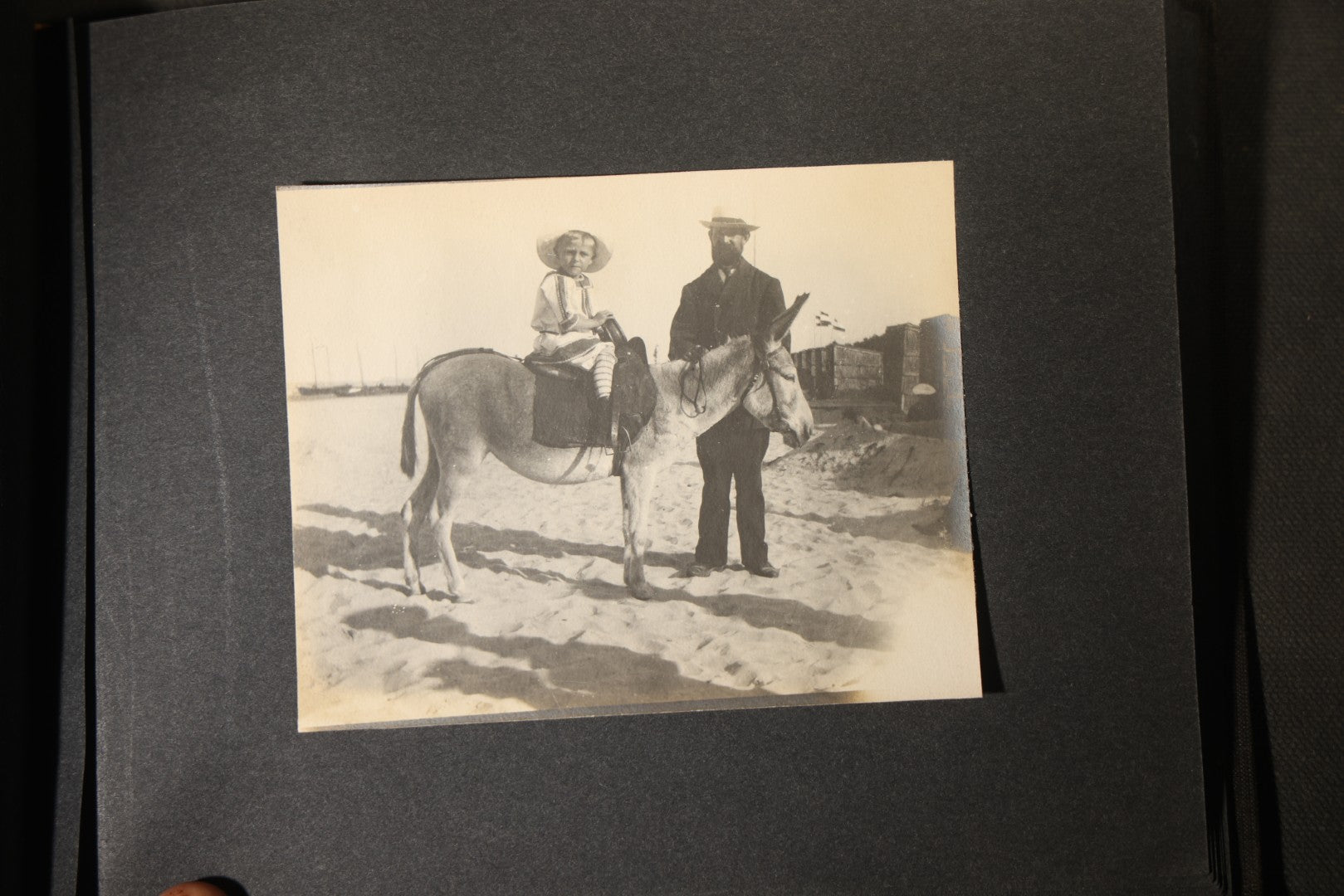 Antique Snapshot Photo Album Containing 25+ Photographs, Circa 1910, Including Beach Scenes, R.P.P.C. of Two Young Men in Cowboy Attire, Sailboat, Swans, Castle Architecture, and Family Portraits