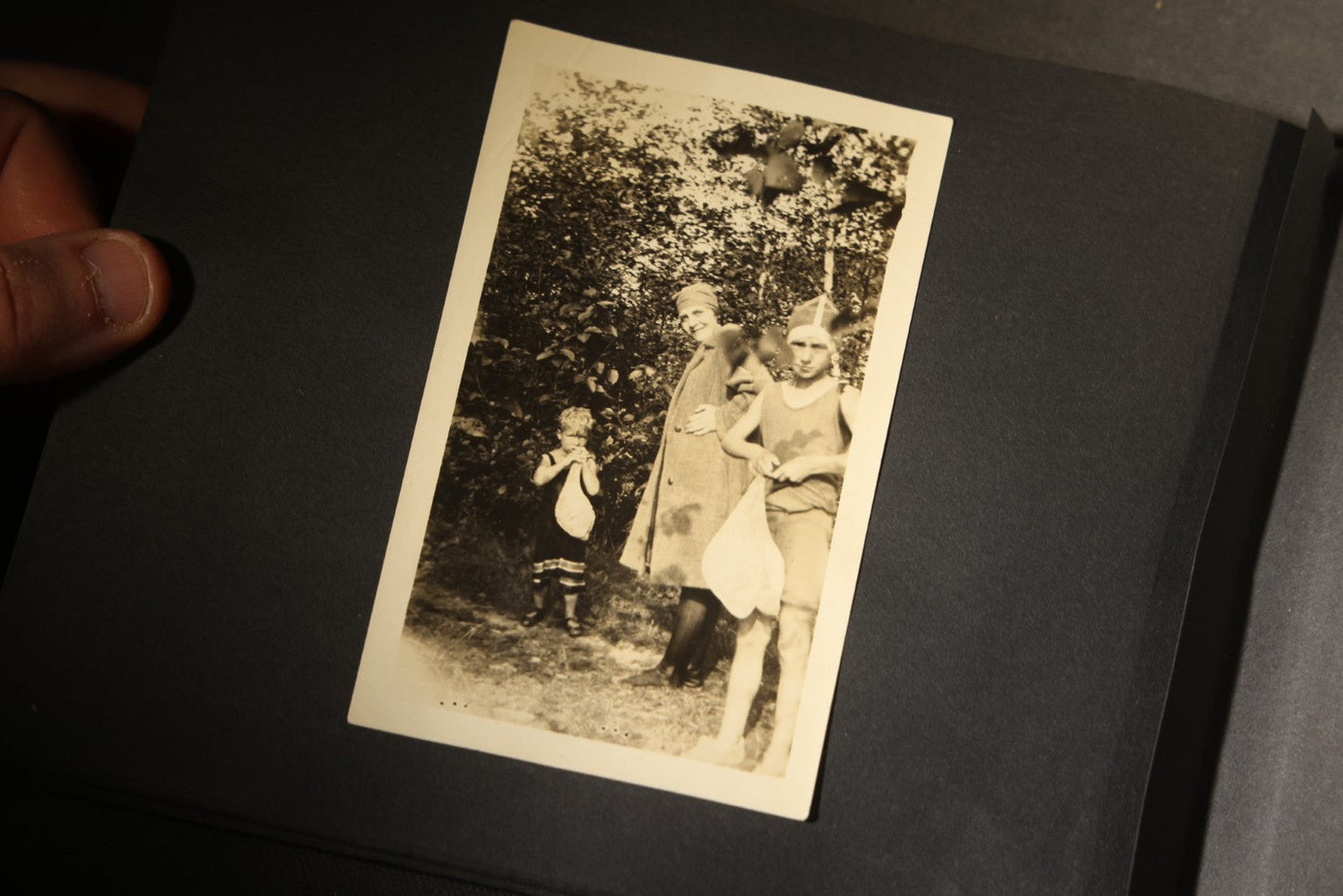 Antique Snapshot Photo Album Containing 30+ Photographs, Circa 1910s-1920s, including Lake and Boating Scenes, Steamboat at Dock, Women Fishing, Swimming, Woman with Dog, and Child with Flag-Decorated Automobile