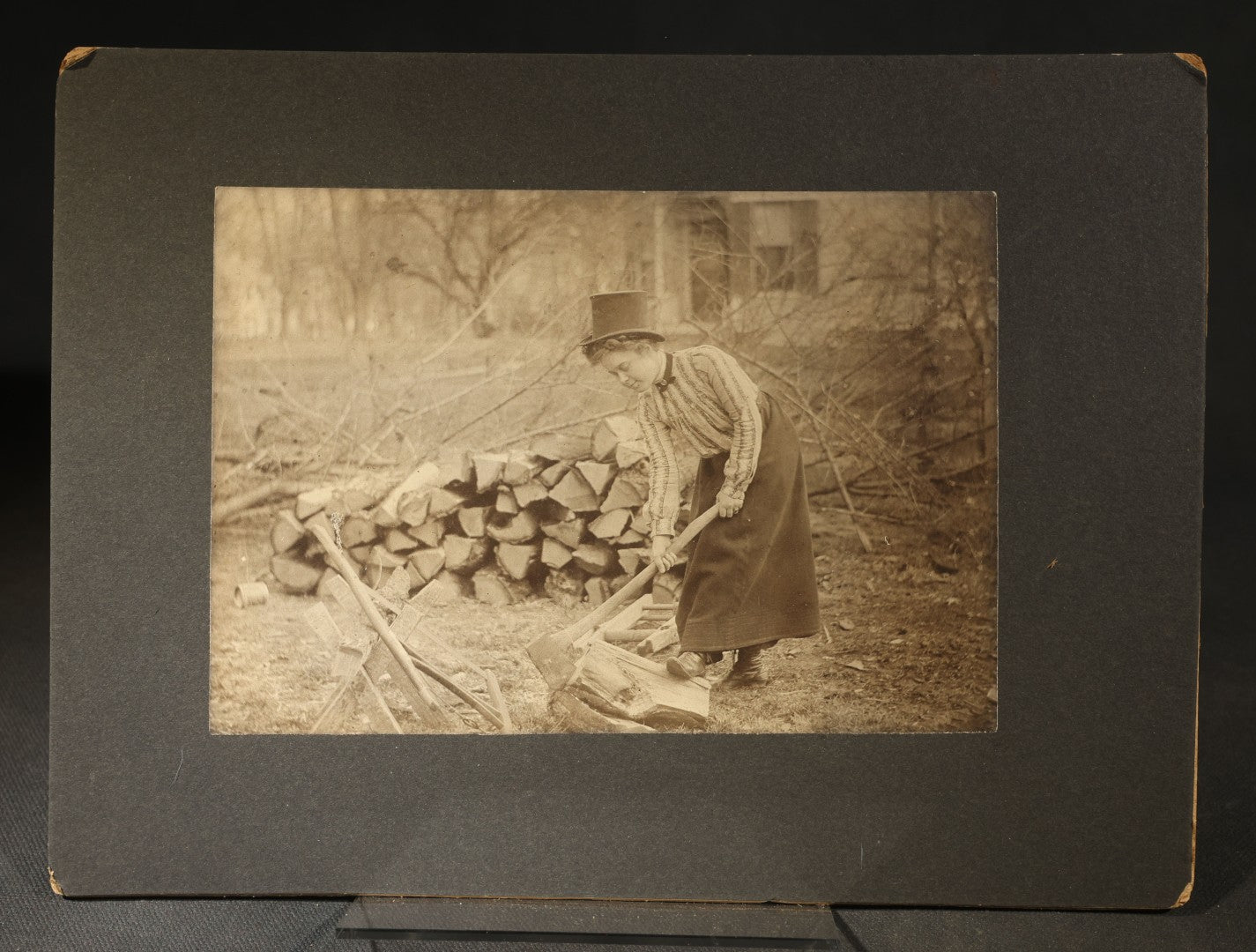 Antique Board-Mounted Photograph of a Woman Chopping Firewood, Inscribed "Mike" on Verso, Dated March 15, 1902