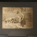 Lot 089 - Antique Board-Mounted Photograph of a Woman Chopping Firewood, Inscribed "Mike" On Verso, Dated March 15, 1902