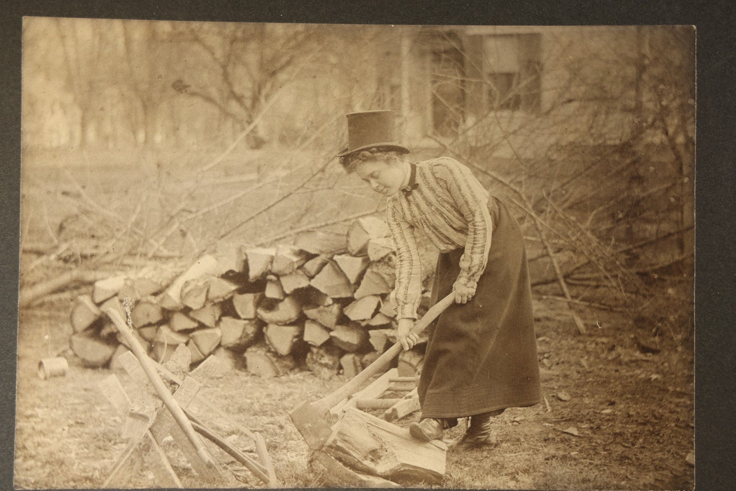 Antique Board-Mounted Photograph of a Woman Chopping Firewood, Inscribed "Mike" on Verso, Dated March 15, 1902